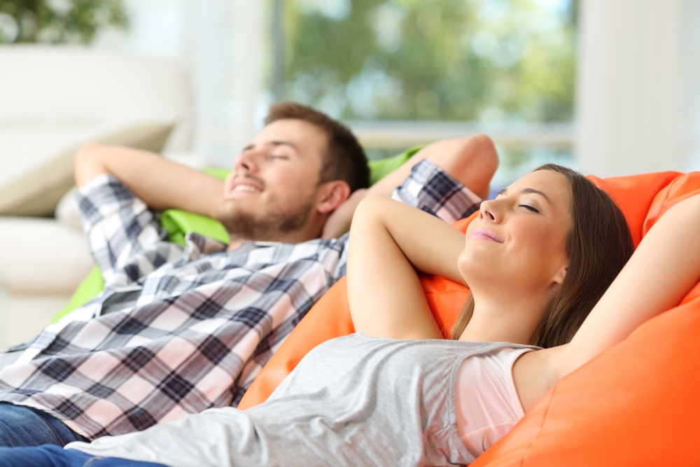 Comfortable Couple Laying Back And Relaxing On Couch