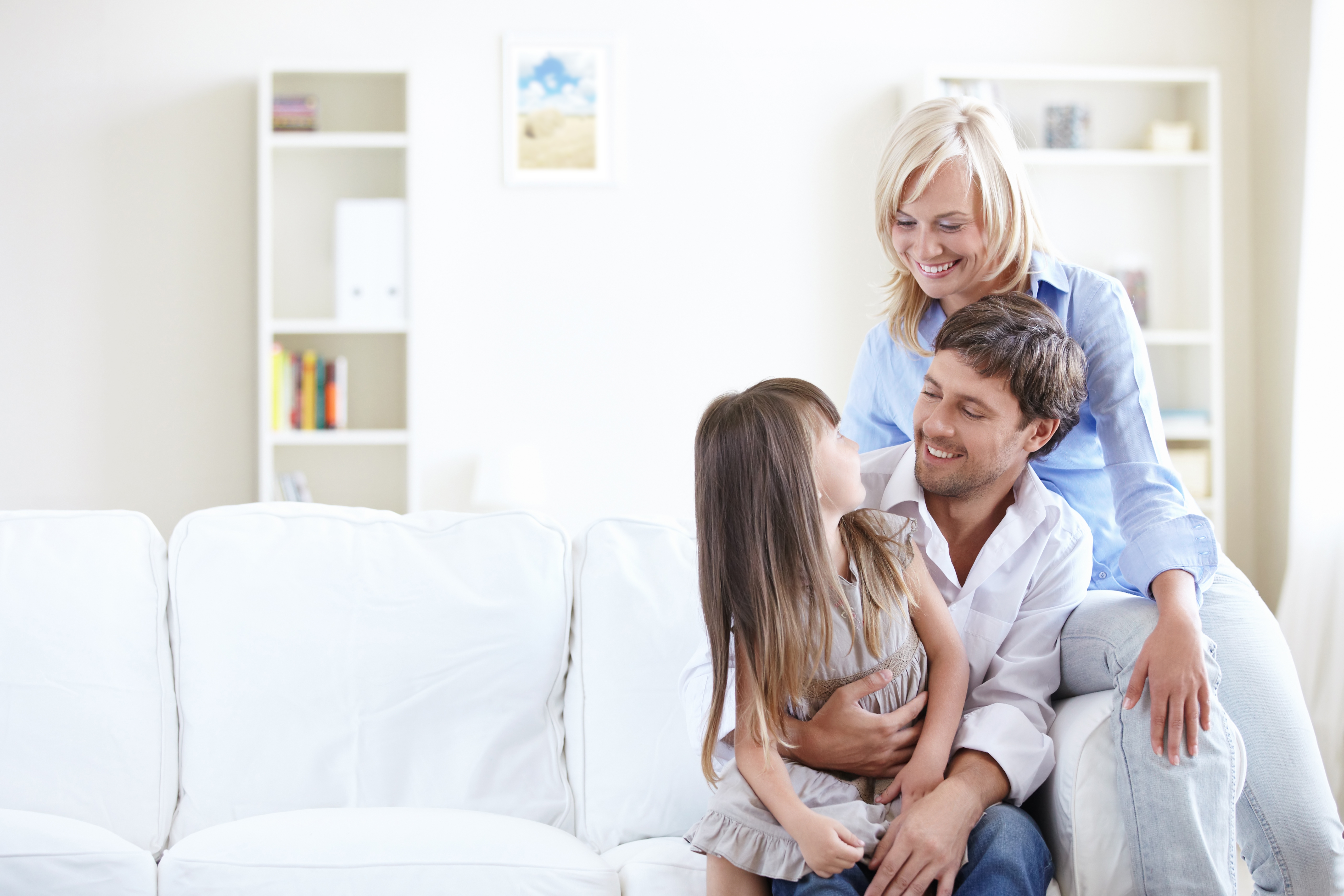 Happy Family Sitting On The Couch