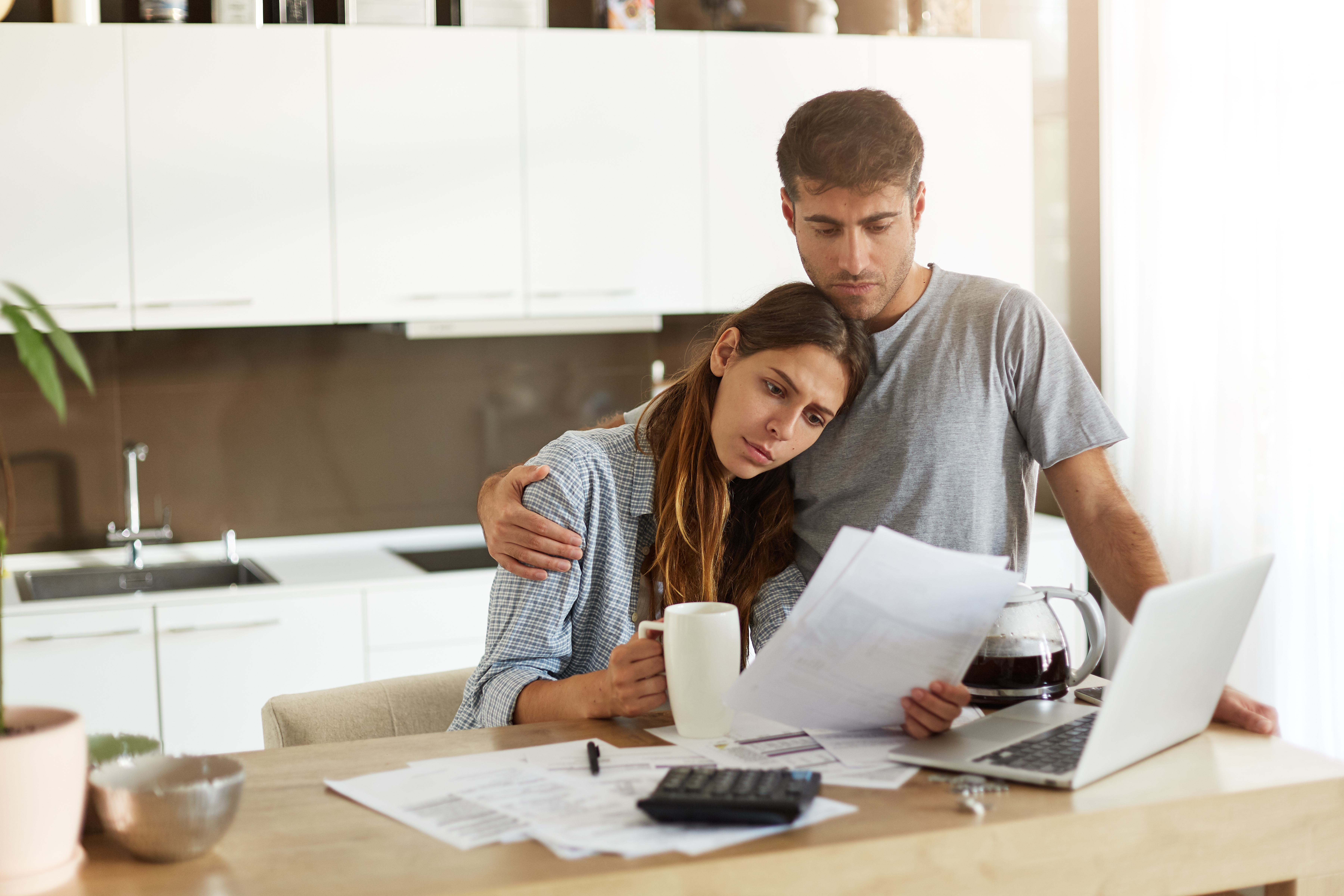 Worried Couple Looking At High Energy Bills