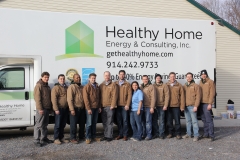 HHEC team in front of truck with brown jackets 