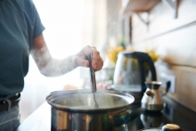 woman cooking on stove at home