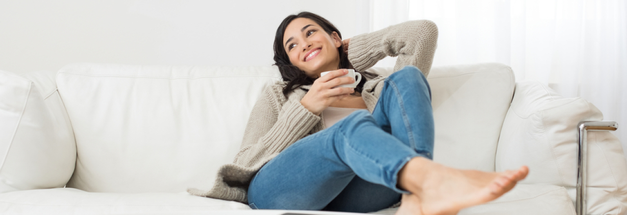 A woman sitting on a couch and breathing deeply