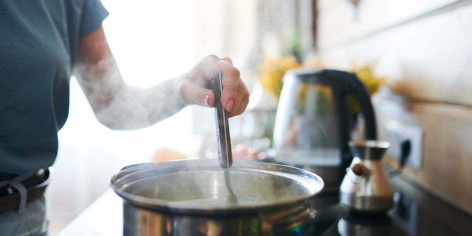 woman cooking on stove at home