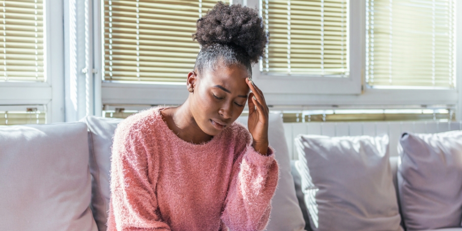 woman at home suffering from a headache