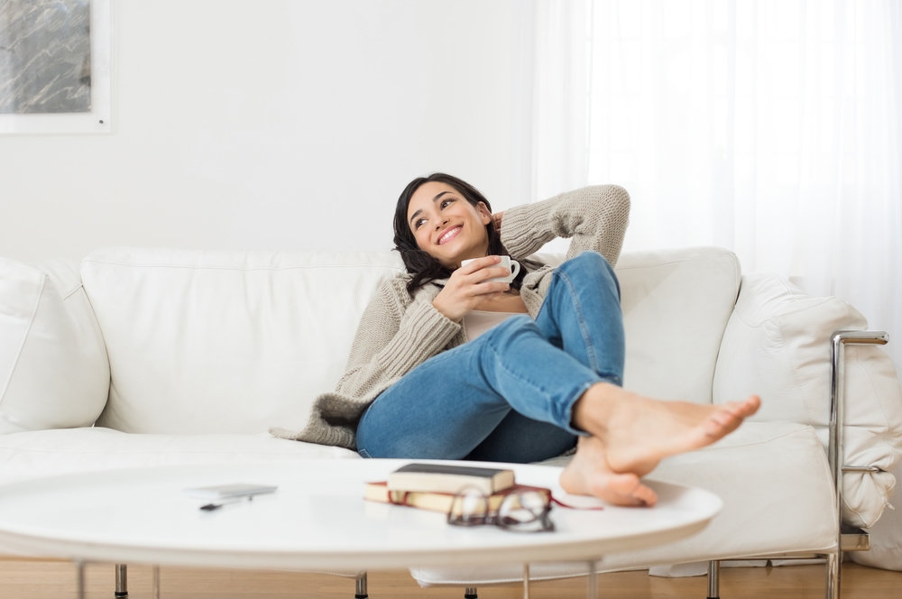 A woman sitting on a couch and breathing deeply