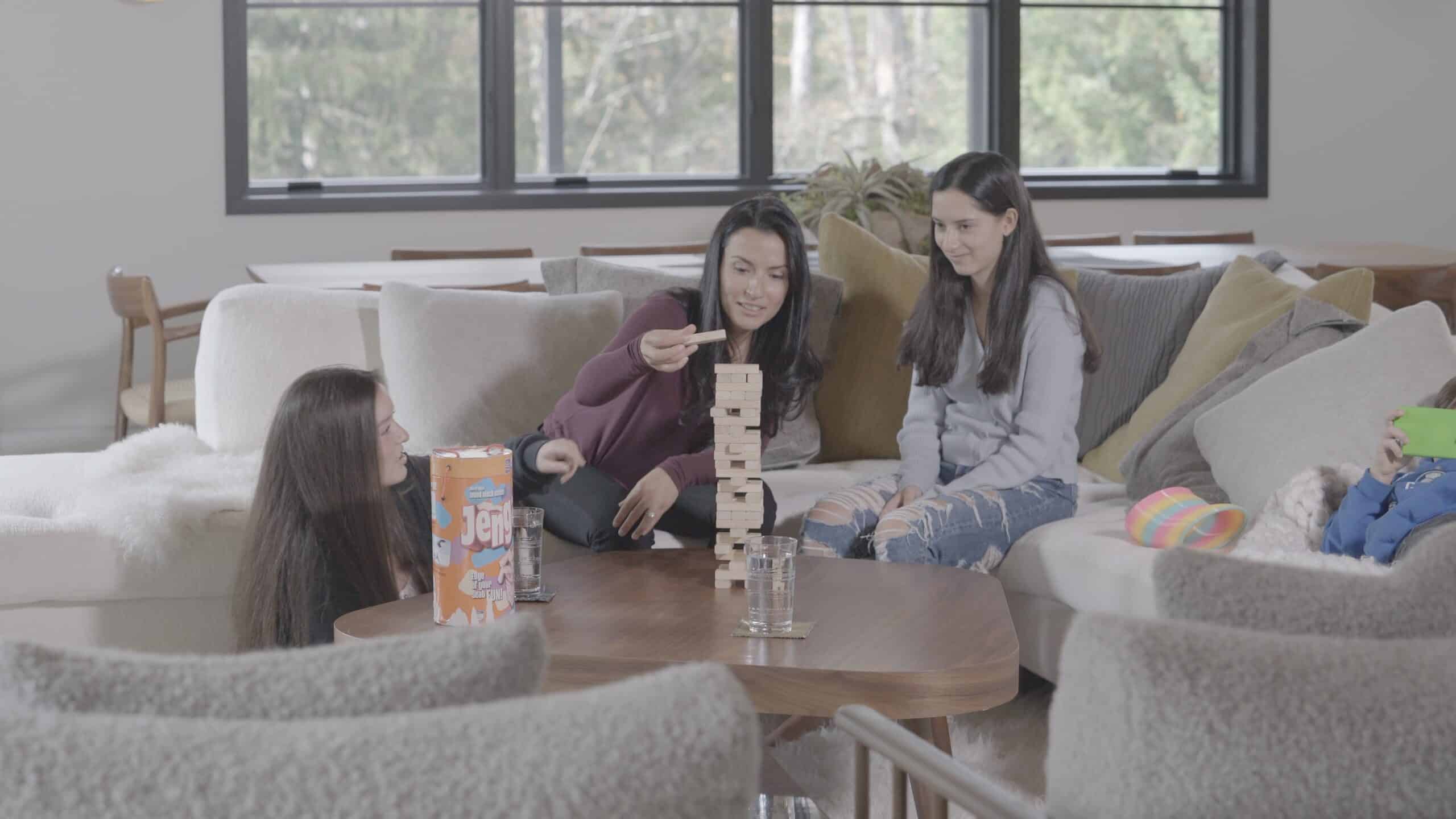 Happy Family Playing Game Together In Living Room